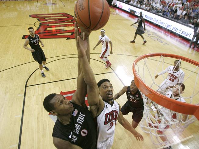 UNLV forward Khem Birch defends a shot by San Diego State forward Skylar Spencer during their Mountain West Conference game Wednesday, March 5, 2014 at the Thomas & Mack Center. 