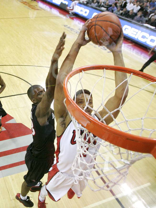 UNLV forward Khem Birch leaps in for a dunk against San Diego State during their Mountain West Conference game Wednesday, March 5, 2014 at the Thomas & Mack Center. The Aztecs won 73-64.