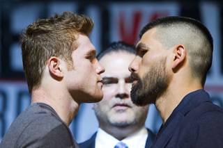 Super-welterweight boxers Canelo Alvarez and Alfredo Angulo face off during a news conference Thursday, March 6, 2014, at MGM Grand. Richard Schaefer, CEO of Golden Boy Promotions, is at center. Alvarez and Angulo, both of Mexico, will fight at MGM Grand Garden Arena on Saturday. Alvarez is a former WBC and WBA 154-pound champion.