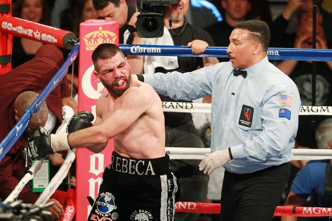 Alfredo Angulo pulls away from referee Tony Weeks after Weeks called stopped his fight with Saul "Canelo" Alvarez during their super welterweight fight at the MGM Grand Garden Arena Saturday, March 8, 2014. Canelo won by TKO in the 10th round.