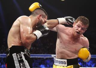 Alfredo Angulo, left, battles it out with Canelo Alvarez, both of Mexico, during their super welterweight fight at the MGM Grand Garden Arena on Saturday, March 8, 2014.