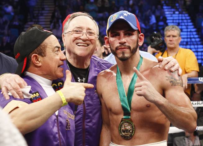 Jorge Linares, right, of Venezuela celebrates his victory over Nihito Arakawa of Japan after their lightweight fight at the MGM Grand Garden Arena on Saturday, March 8, 2014. 