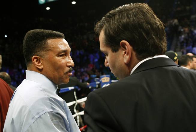 Referee Tony Weeks, left, talks with Francisco Aguilar, chairman of the Nevada State Athletic Commission, after stopping the super welterweight between Canelo Alvarez and Alfredo Angulo, both of Mexico, at the MGM Grand Garden Arena Saturday, March 8, 2014. 