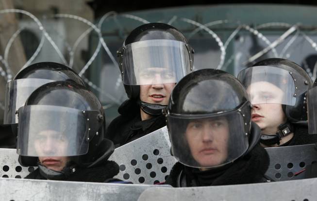 Ukrainian riot police stand at the entrance of the regional administrative building during a pro-Russia rally in Donetsk, Ukraine, on Saturday, March 8, 2014. Pro-Russian activists continued to gather on Saturday in the eastern Ukrainian city of Donetsk, as Russia was reported to be reinforcing its military presence in Crimea.