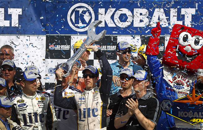Brad Keselowski holds his trophy in victory lane after winning the Kobalt 400 NASCAR Sprint Cup Series race at the Las Vegas Motor Speedway Sunday, March 9, 2014.