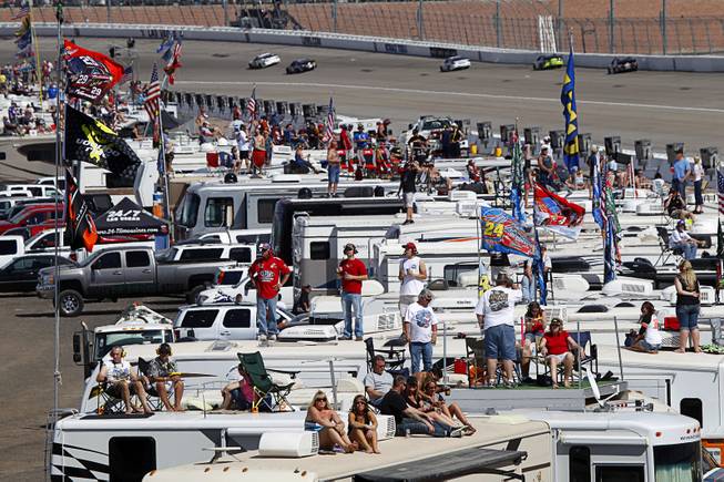 Fans watch from recreational vehicles in the infield during the Kobalt 400 NASCAR Sprint Cup Series race at the Las Vegas Motor Speedway Sunday, March 9, 2014.