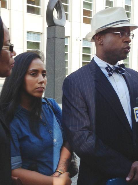 In this July 3, 2013, file photo, former Metropolitan Detention Center guard Nancy Gonzalez, center, listens as her attorney, Anthony Rico, speaks to members of the media outside the federal courthouse in the Brooklyn borough of New York. Gonzalez gained notoriety by conceiving a baby behind bars with a cop killer. Although she claims to have had clandestine sexual encounters with at least eight co-workers and a second inmate while on duty at the Metropolitan Detention Center, it remains unclear if anyone else has been disciplined.