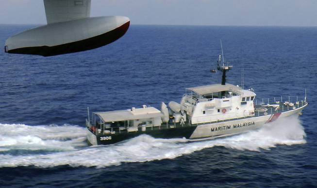 In this photo released by Malaysian Maritime Enforcement Agency, a patrol vessel of Malaysian Maritime Enforcement Agency searches for the missing Malaysia Airlines plane off Tok Bali Beach in Kelantan, Malaysia, on Sunday, March 9. Military radar indicates that the missing Boeing 777 jet may have turned back, Malaysia’s air force chief said Sunday as scores of ships and aircraft from across Asia resumed a hunt for the plane and its 239 passengers.