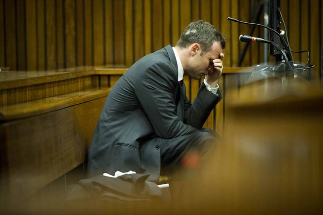 Oscar Pistorius puts his hand to his head while listening to cross questioning about the events surrounding the shooting death of his girlfriend, Reeva Steenkamp, during his trial in Pretoria, South Africa, on Friday, March 7. Pistorius is charged with murder for the shooting death of Steenkamp on Valentines Day 2013.