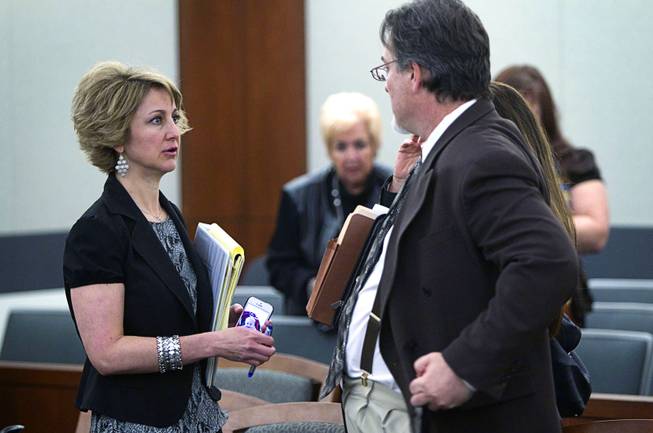 Attorney Lisa Zastrow, left, representing the Animal Foundation, speaks with Steven Sweiker, center, Clark County Deputy District Attorney, during a hearing at the Regional Justice Center Tuesday, March 11, 2014. Judge Kenneth Cory kept a temporary restraining order in place preventing an Animal Foundation raffle of puppies rescued in a  Jan. 27 fire at the Prince and Princess Pet Shop. An evidentiary hearing is scheduled for March 19.