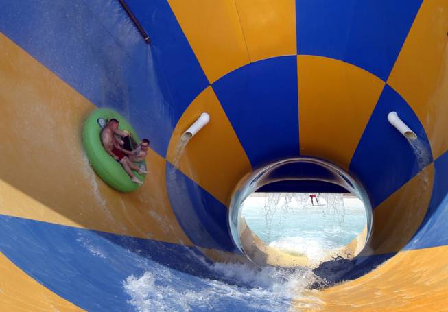 Riders cool off on the Tornado water slide on a hot sunny day at Darien Lake Theme Park Resort in Darien Center, N.Y., Wednesday, June 8, 2011. 