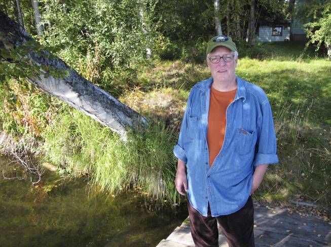 In this Sept. 3, 2010, file photo, author Joe McGinniss, who was working on a book on former Alaska Gov. Sarah Palin, stands near the home he rented next to Palin's home in Wasilla, Alaska.