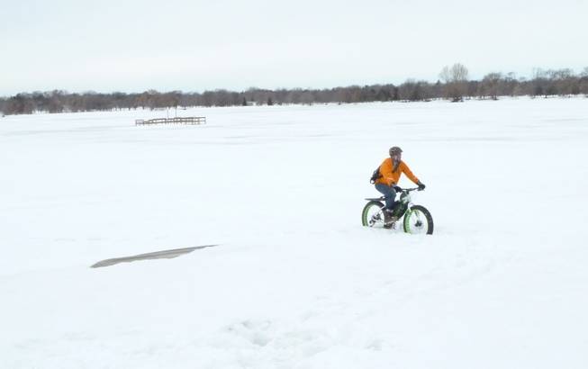 People ride bikes in Minnesota year round. Even in the dead of winter when temperatures go below zero and the snowdrifts dwarf houses. Here, Nick Mason, of the Bicycle Alliance of Minnesota, negotiates some wintry scenes, March 11, 2014.