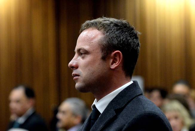 In this photo taken Monday March 10, 2014, Oscar Pistorius cries as he listens to cross questioning about the events surrounding the shooting death of his girlfriend Reeva Steenkamp, in court during his trial in Pretoria, South Africa. Pistorius is charged with the shooting death of Steenkamp, on Valentines Day in 2013.