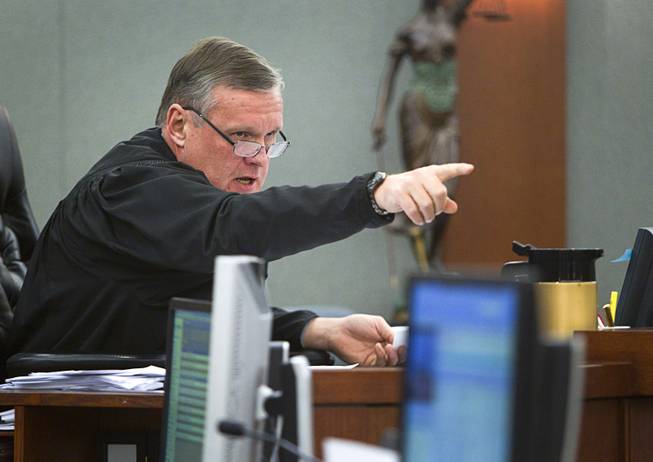 Judge David Barker speaks to attorneys during an arraignment for pet shop owner Gloria Lee and co-defendant Kirk Bills at the Regional Justice Center Wednesday, March 12, 2014. The pair pleaded not guilty to charges of torching the pet shop where 27 puppies were rescued, and a judge rejected a bid for lower bail.