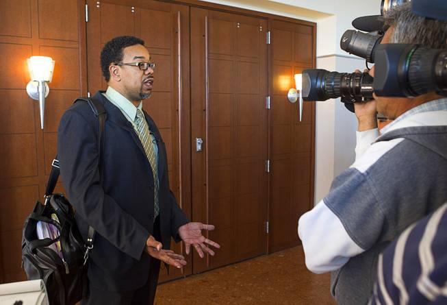 Defense attorney Roger Bailey, representing Kirk Bills, answers questions from reporters following an arraignment at the Regional Justice Center Wednesday, March 12, 2014. Bills and pet shop owner Gloria Lee pleaded not guilty to charges of torching the pet shop where 27 puppies were rescued, and a judge rejected a bid for lower bail.