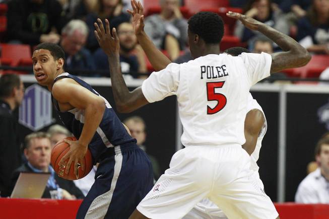 Utah State guard Marcel Davis is pressured by San Diego State's Dwayne Polee and Xavier Thames during their Mountain West Conference tournament game Thursday, March 13, 2014 at the Thomas & Mack Center.