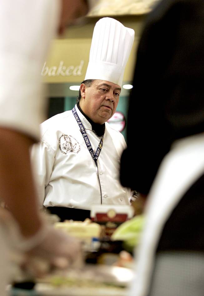 Chef Instructor Ruben Munoz Jr. observes the work of his Southwest Career and Technical Academy students with the Culinary Collision at the Whole Foods Market in Town Square on Thursday, March 13, 2014.