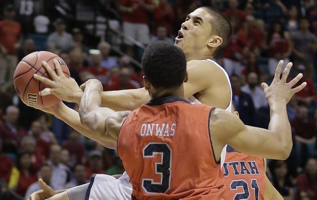 Arizona's Nick Johnson is fouled by Utah's Princeton Onwas (3) while shooting in the first half of an NCAA Pac-12 conference tournament college basketball game, Thursday, March 13, 2014, in Las Vegas.