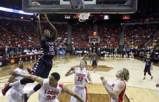 Fresno State's Paul Watson (22) shoots over the New Mexico defense during the first half of an NCAA college basketball game in the quarterfinals of the Mountain West Conference tournament, Thursday, March 13, 2014, in Las Vegas. (AP Photo/Isaac Brekken)