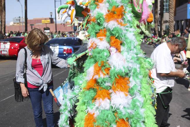 An attendee looks at a vendor's merchandise during the annual St. Patrick's Day parade in Henderson Saturday, March 15, 2014.