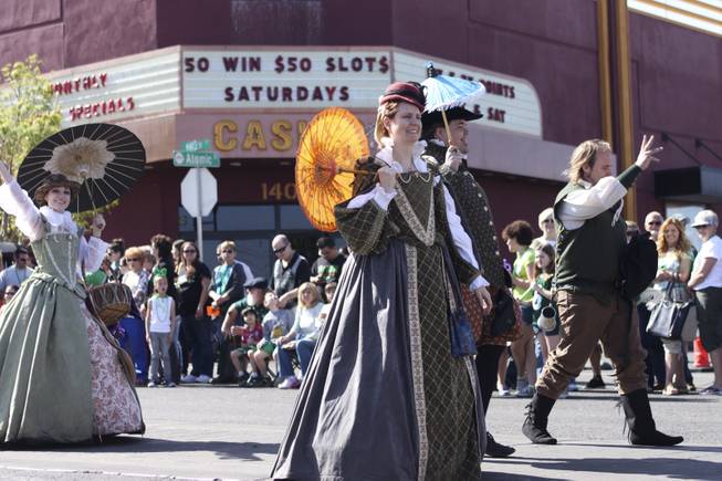 Members of the House of Stuart Reenactment Guild wave at the crowd during the annual St. Patrick's Day parade in Henderson Saturday, March 15, 2014.