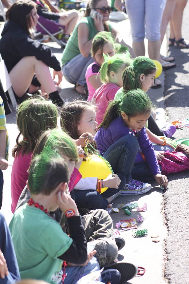 Children with their hair painted green look on during the annual St. Patrick's Day parade in Henderson Saturday, March 15, 2014.