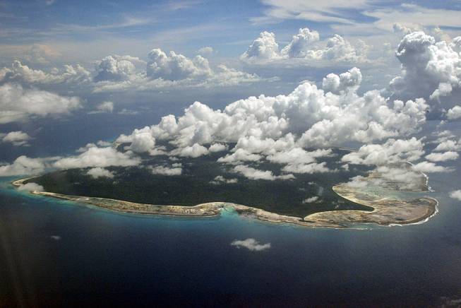 In this Nov. 14, 2005, file photo, clouds hang over the North Sentinel Island, in India's southeastern Andaman and Nicobar Islands. India used heat sensors on flights over hundreds of uninhabited Andaman Sea islands Friday, March 14, 2014, and will expand its search for the missing Malaysia Airlines jet farther west into the Bay of Bengal, officials said.