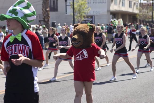 The Brown Junior High mascot performs with the cheer squad during the annual St. Patrick's Day parade in Henderson Saturday, March 15, 2014.