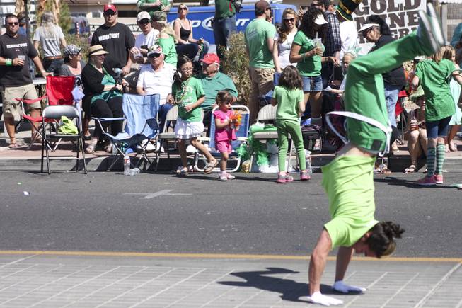 A tumbler backflips down the street during the annual St. Patrick's Day parade in Henderson Saturday, March 15, 2014.