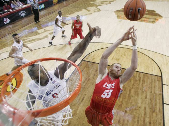 New Mexico center Alex Kirk and San Diego State forward .Skylar Spencer leap for a rebound during their Mountain West Conference tournament championship game Saturday, March 15, 2014 at the Thomas & Mack Center. The Lobos won their third straight title, defeating the Lobos 64-58.