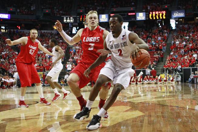 New Mexico guard Hugh Greenwood defends San Diego State guard Xavier Thames during their Mountain West Conference tournament championship game Saturday, March 15, 2014 at the Thomas & Mack Center. The Lobos won their third straight title, defeating the Lobos 64-58.