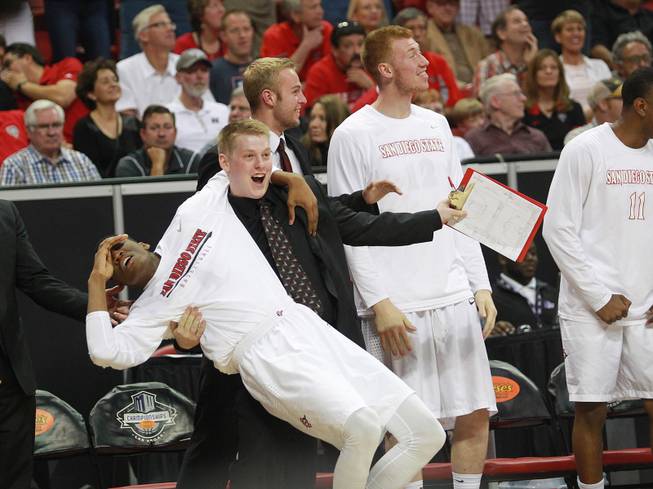 The San Diego State bench reacts as they pull even with New Mexico during their Mountain West Conference tournament championship game Saturday, March 15, 2014 at the Thomas & Mack Center. The Lobos won their third straight title, defeating the Lobos 64-58.