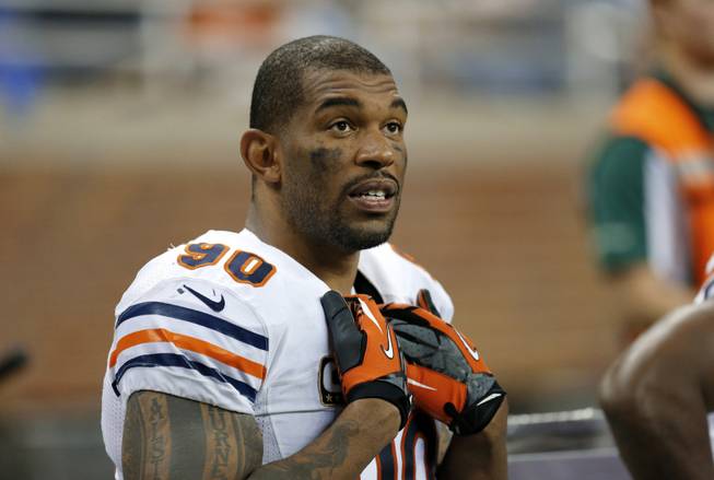 In this Sept. 29, 2013, file photo, Chicago Bears defensive end Julius Peppers watches from the bench during the fourth quarter of an NFL football game against the Detroit Lions in Detroit. The Bears released eight-time Pro Bowl defensive end Peppers, and he signed with the Green Bay Packers.