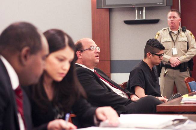 Cristian Diaz, with his head down, waits for Judge Jerome Tao to enter the court room prior to his sentencing hearing Monday, March 17, 2014. Diaz, 20, pleaded guilty last year to two counts of driving while under the influence of a controlled substance causing death and substantial bodily harm.