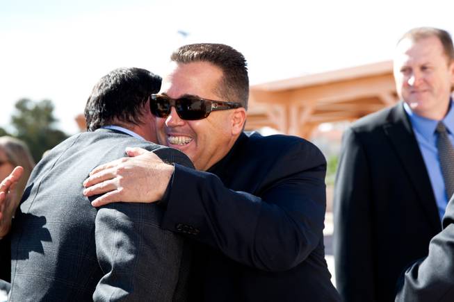 Brendan Gaughan, a grandson of Jackie Gaughan, receives a hug from his friend Lee Rampolla during the memorial mass for John Davis "Jackie" Gaughan held at St. Viator Catholic Church in Las Vegas on St. Patrick's Day, March 17, 2014.