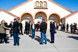 Long-time friends and family gather outside the sanctuary waiting to attend the memorial mass for John Davis 