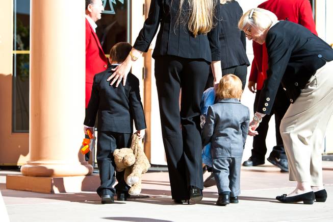 The youngest great grandchildren of John Davis "Jackie" Gaughan (from left) 3-year-old Michael James Gaughan and 17-month-old Ryland Gaughan are escorted into the memorial mass for their grandfather at St. Viator Catholic Church in Las Vegas on St. Patrick's Day, March 17, 2014.