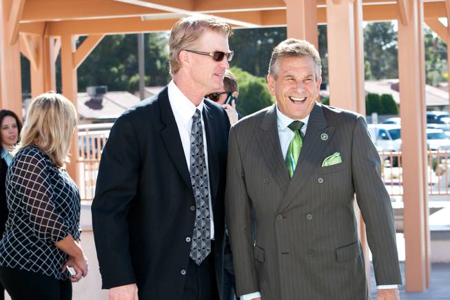 Honoring the Irish heritage of Jackie Gaughan, Steve Schorr is seen wearing a green tie while visiting with Steve Stallworth, left, at the memorial mass for John Davis "Jackie" Gaughan held at St. Viator Catholic Church in Las Vegas on St. Patrick's Day, March 17, 2014.