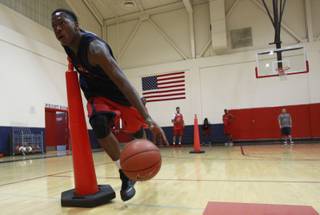 Findlay Prep guard Renathan Ona Embo takes part in a ball handling drill during practice Tuesday, March 18, 2014.