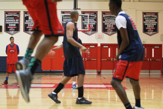 Banners on the wall attest to the success of the Findlay Prep basketball team, seen during practice Tuesday, March 18, 2014.