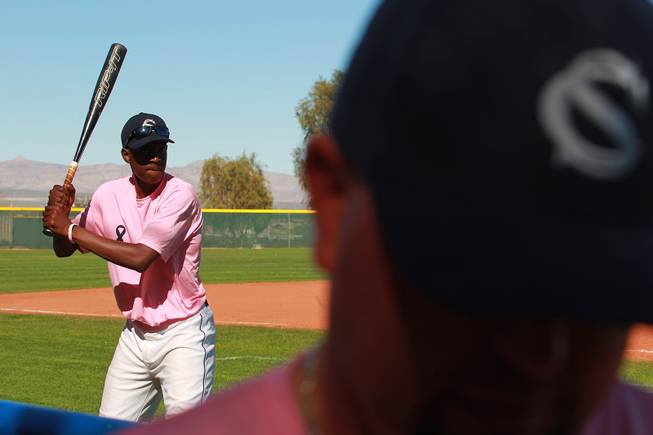 Canyon Springs player Rashaad Jones takes some practice swings during their game against Western Wednesday, March 19, 2014. The Pioneers wore pink jerseys for the game for cancer awareness and to honor parents of two of the players who died from cancer in the past year.