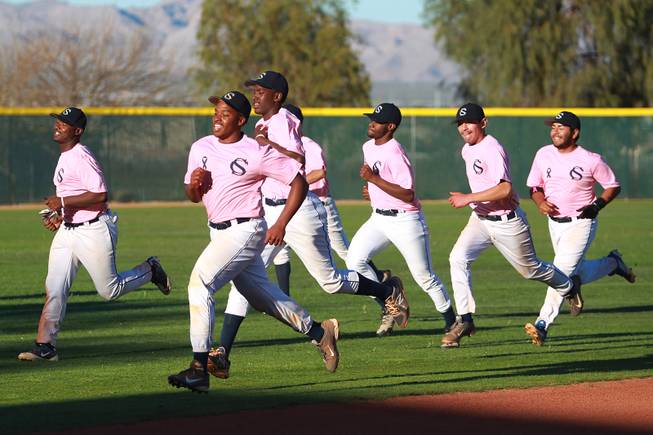 Canyon Springs players runs sprints after their game against Western Wednesday, March 19, 2014. The Pioneers wore pink jerseys for the game for cancer awareness and to honor parents of two of the players who died from cancer in the past year.