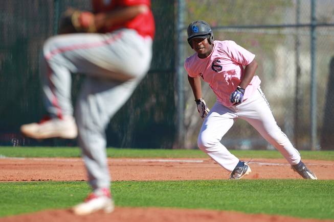 Canyon Springs player Joe Jackson breaks for second during their game against Western Wednesday, March 19, 2014. The Pioneers wore pink jerseys for the game for cancer awareness and to honor parents of two of the players who died from cancer in the past year.