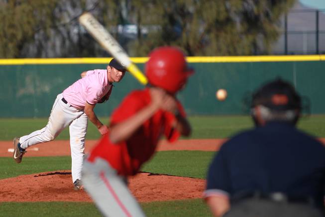 Canyon Springs pitcher Alex Molina throws to a Western player during their game  Wednesday, March 19, 2014. The Pioneers wore pink jerseys for the game for cancer awareness and to honor parents of two of the players who died from cancer in the past year.
