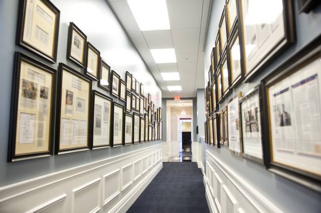 A hallway covered with framed articles at the Robert Eglet Advocacy Center Wednesday, March 19, 2014.