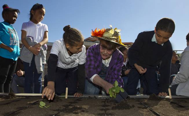 Student Azia La Rue, 9, Judith Allan and Shakur Ahmed, 9, join others from Joseph E. Thiriot Elementary School and the Create A Change Now organization to plant an edible garden on Wednesday, March 19, 2014.