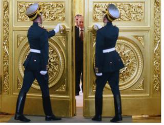 Honor guards open the doors for Russian President Vladimir Putin followed by Crimean leaders entering the hall for the signing ceremony of a treaty for Crimea to join Russia,  in the Kremlin in Moscow, Tuesday, March 18, 2014. 