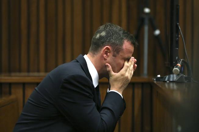 Oscar Pistorius listens to ballistic evidence being given in court in Pretoria, South Africa, Wednesday, March 19, 2014. Pistorius is on trial for the murder of his girlfriend Reeva Steenkamp on Valentine's Day in 2013.
