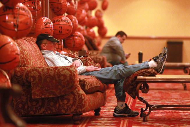 A man takes a nap in a hallway at the South Point during the second round of the NCAA basketball tournament Thursday, March 20, 2014.